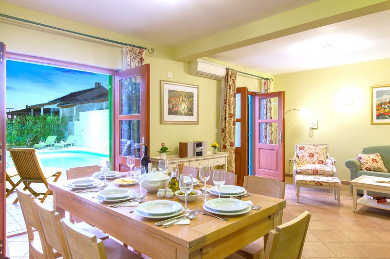 Dining room on the ground floor at Villa Mare with opened French door and the swimming pool view