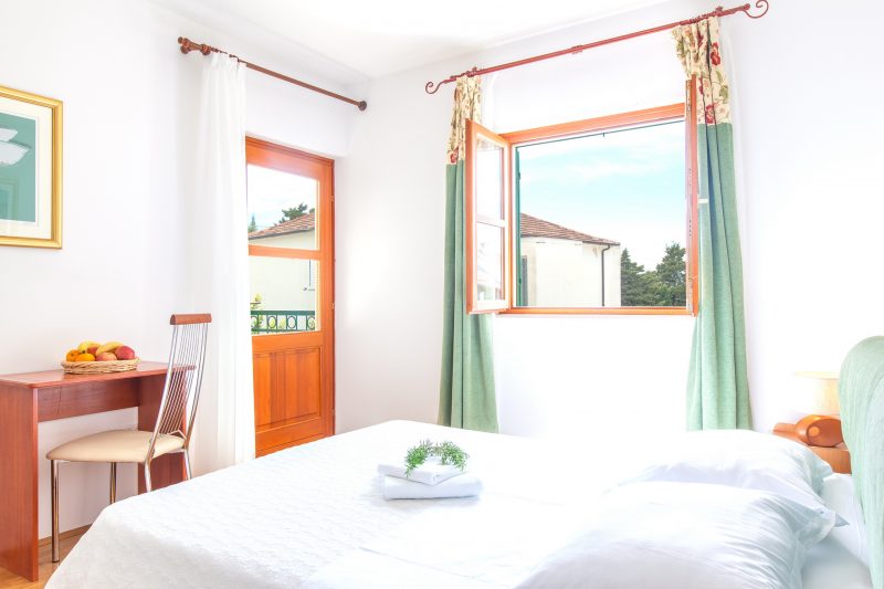 Double bedded room with balcony and window